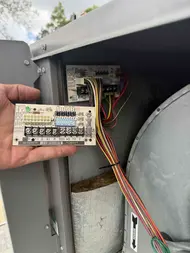 Technician repairing the air handler control board during AC repair in Rancho Cordova